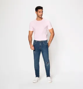 Jean slim fit con rotos localizados